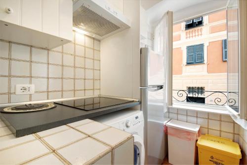a kitchen with a refrigerator and a window at Oceane Paradise - Churchill in Levanto