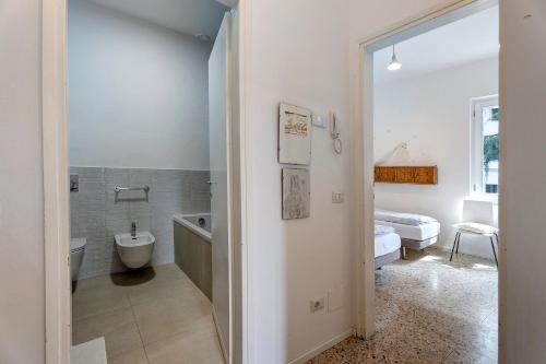 a bathroom with a tub and a toilet and a sink at Casa romantica in Ispra