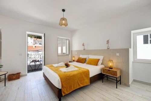 a bedroom with a large bed with a yellow blanket at Villa Xique 9 in Monchique