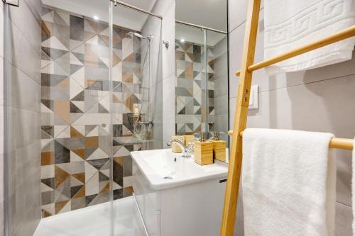 a white bathroom with a sink and a shower at Villa Xique 9 in Monchique