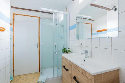 a bathroom with a sink and a shower at Maison à Saint-Blimont in Saint-Blimont