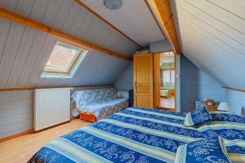 a bedroom with a bed and a chair in a attic at Maison à Saint-Blimont in Saint-Blimont