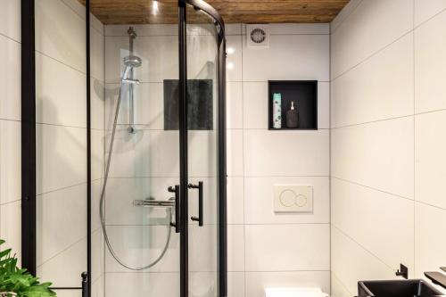 a shower with a glass door in a bathroom at Haus Auner Top 5b in Westendorf