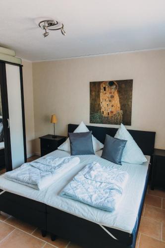 a large bed with blue pillows in a bedroom at Haus Piratennest in Grömitz