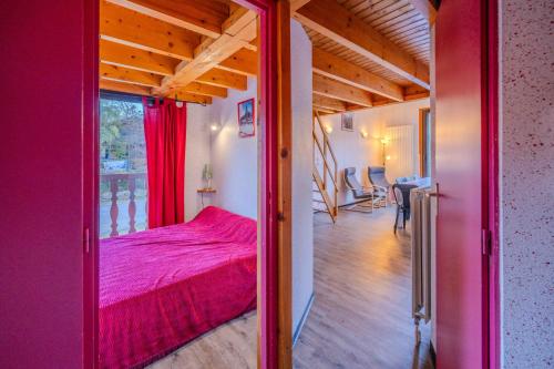 a bedroom with a red bed in a room at Apt Framboise Les Monts d'olmes in Montferrier