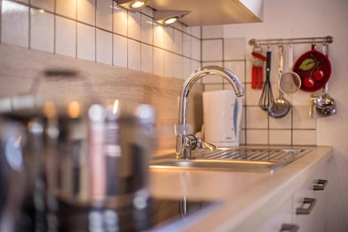 a kitchen sink with a faucet and a counter top at Golserhof Kristall in Cadipietra