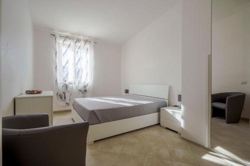 a bedroom with a bed and two chairs and a window at Villa Terry in Ostuni