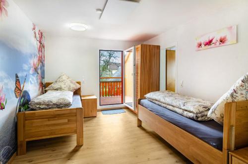 a bedroom with two beds and a window at Li-Do-Bo 01 in Herdwangen-Schönach