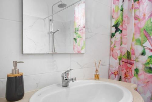 a bathroom with a sink and a shower curtain at Casa da Ribeira da Janela in Porto Moniz