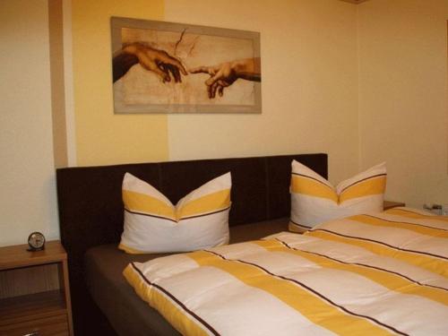 a bedroom with two beds and a painting on the wall at Waldhaus Jakober in Maasdorf