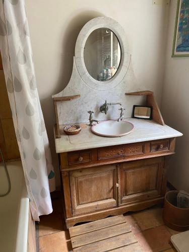 a bathroom with a sink and a mirror at Buvolaccia in Sampolo