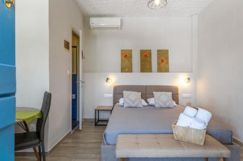 a bedroom with a bed and a table in a room at Porto Galini Kalloni in Agios Ioannis