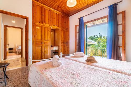 a bedroom with a bed and a large window at Princess House in Sidari
