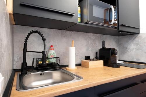a kitchen counter with a sink and a candle at Fw Moonlight mit Sauna, Schwimmbad in Schönwald
