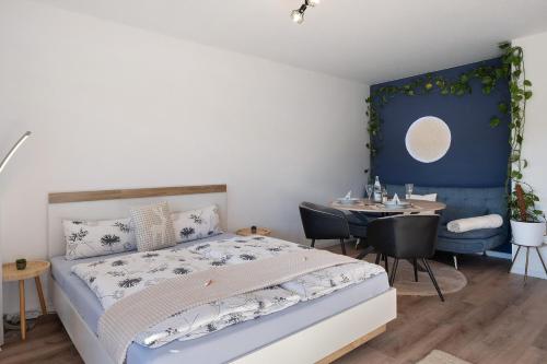 a bedroom with a bed and a dining room with a table at Fw Moonlight mit Sauna, Schwimmbad in Schönwald