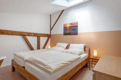a bedroom with a large bed with a wooden frame at Ferienwohnung Junge 3 in Lohe-Rickelshof