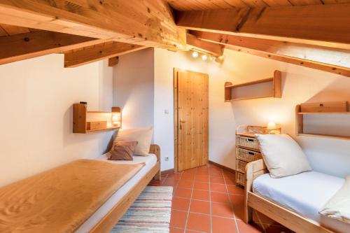 a small room with two beds and a desk at Weingut Lieselehof Apt Panorama in Caldaro