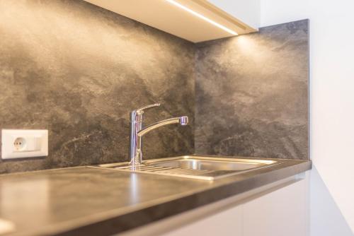 a kitchen sink with a chrome faucet at Rosalpina Apt 2 in San Vigilio Di Marebbe