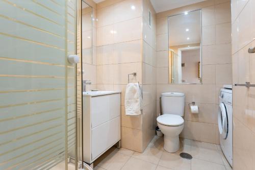 a bathroom with a toilet and a sink and a mirror at Sunny studio with seaview in Fuengirola