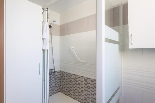 a shower with a glass door in a bathroom at Las Alondras in Gandía
