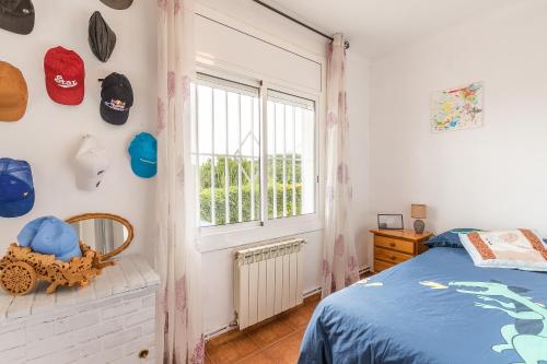 a bedroom with a bed and a window at Can Fogars in Fogás de Tordera