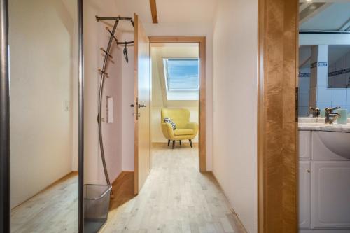 a hallway with a yellow chair in a room at Luxuriöses Penthouse-appartement in Höchst