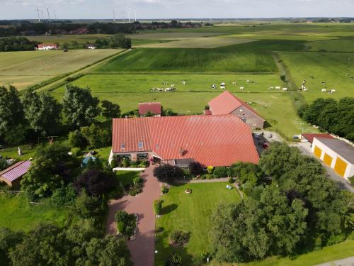 an aerial view of a farm with a red roof at Ferienhof Renate Sassen in Werdum
