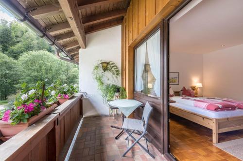 a bedroom with a bed and a window at Ferienwohnung Förchensee in Ruhpolding