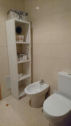a bathroom with a white toilet and a sink at Faro City Center Apartment I in Faro