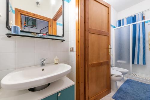 a bathroom with a sink and a toilet at Villetta Lelu' in Villasimius