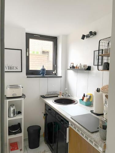 a kitchen with a sink and a window at Ruhiges Apartment Münster Baumberge in Nottuln