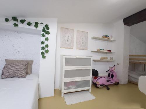 a bedroom with a pink scooter parked in a room at Ca Les Nines 2 in Pinell de Bray