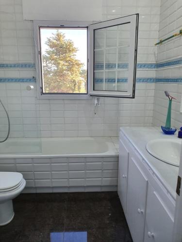a bathroom with a tub and a toilet and a sink at Finca Campo Viejo in Isla Cristina