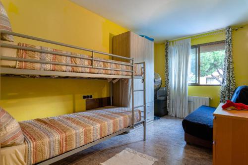 two bunk beds in a room with yellow walls at Apartamento Costa Brava in Blanes