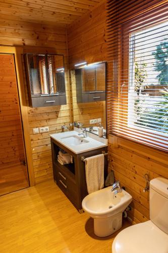 a bathroom with a sink and a toilet at Casa de Madera en Calafell in Calafell