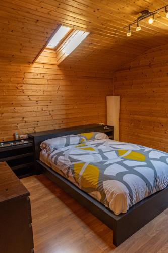 a bedroom with a bed in a wooden room at Casa de Madera en Calafell in Calafell