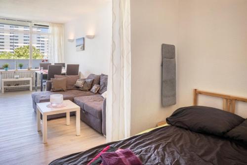 a living room with a couch and a table in a room at Ferienpark N3 -3 in Heiligenhafen