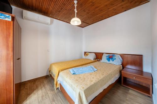 a small bedroom with a bed and a wooden ceiling at Grenta Country House in Corfu