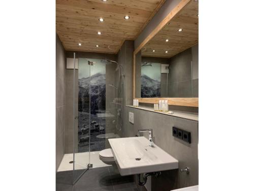 a bathroom with a sink and a shower at Ferienwohnung Max 2 in Garmisch-Partenkirchen