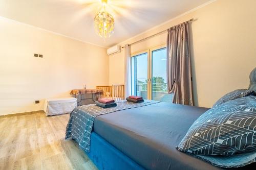 a bedroom with a large bed and a large window at The Mountain Villa in Aleimmatádes