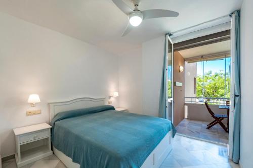 a bedroom with a bed and a sliding glass door at Kiko Las Americas in Isla Cristina