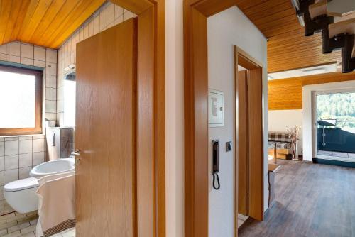 a bathroom with a toilet and a sink at Haus Erika Ferienwohnung 2 in Bad Teinach-Zavelstein