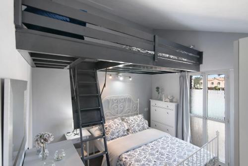 a bedroom with a bunk bed with a ladder at Place Oasis Green Luxury Pool in Maspalomas