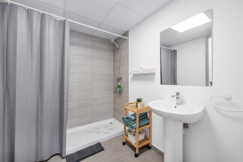 a bathroom with a sink and a shower curtain at Lopimar Bonito in Canet de Berenguer