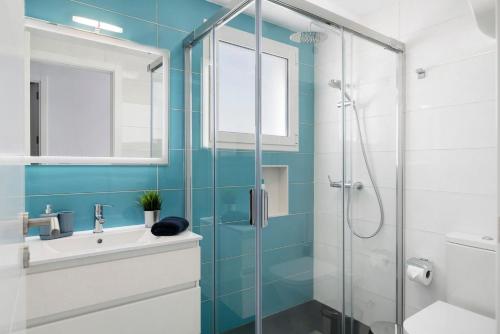 a bathroom with a glass shower and a sink at Noray 2 in La Santa