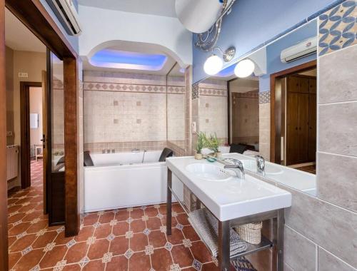a bathroom with a tub and a sink at El Paladin in Zufre