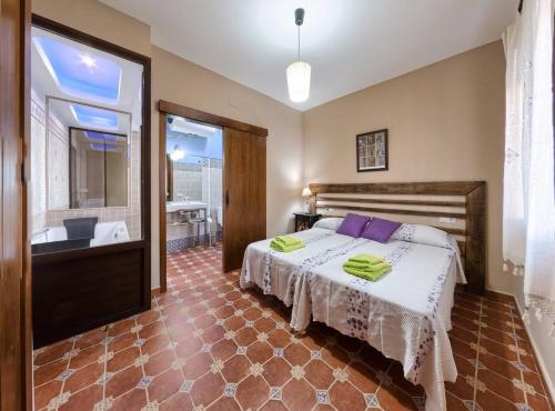 a bedroom with a bed and a tub and a sink at El Paladin in Zufre