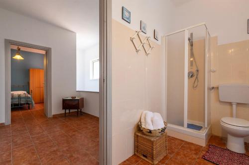 a bathroom with a toilet and a walk in shower at Il Giglio Rosa in Sorso