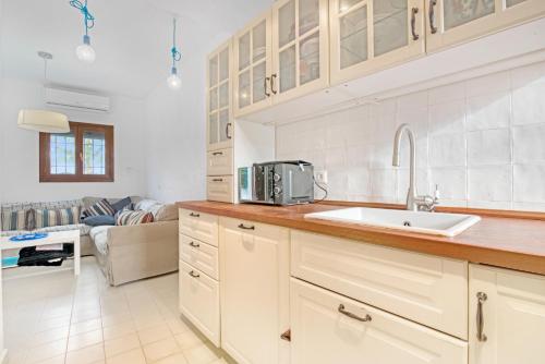 a kitchen with a sink and a counter top at Ca Xotxim in Altea