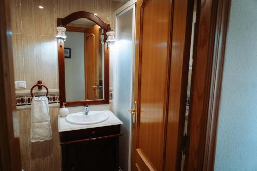 a bathroom with a sink and a mirror at Ca Margarita in Benegida
